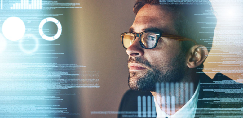 Man wearing glasses looking at screen to the left