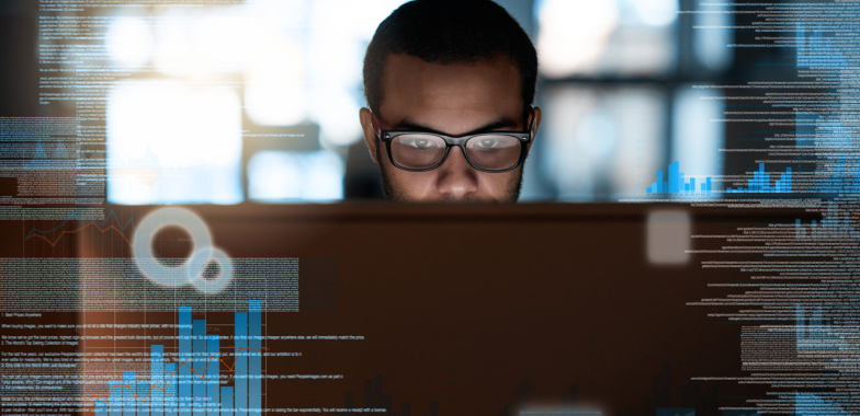 Man looking at computer screen with screen covering some of his face