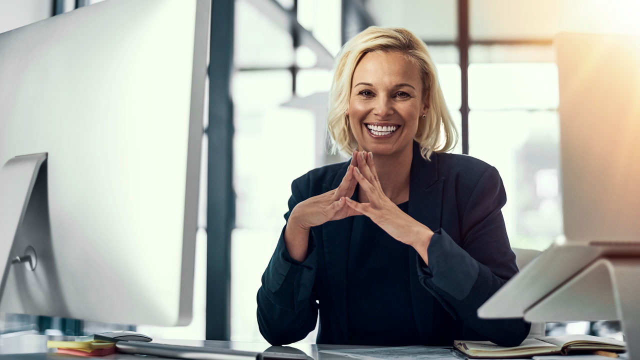Woman at desk smiling