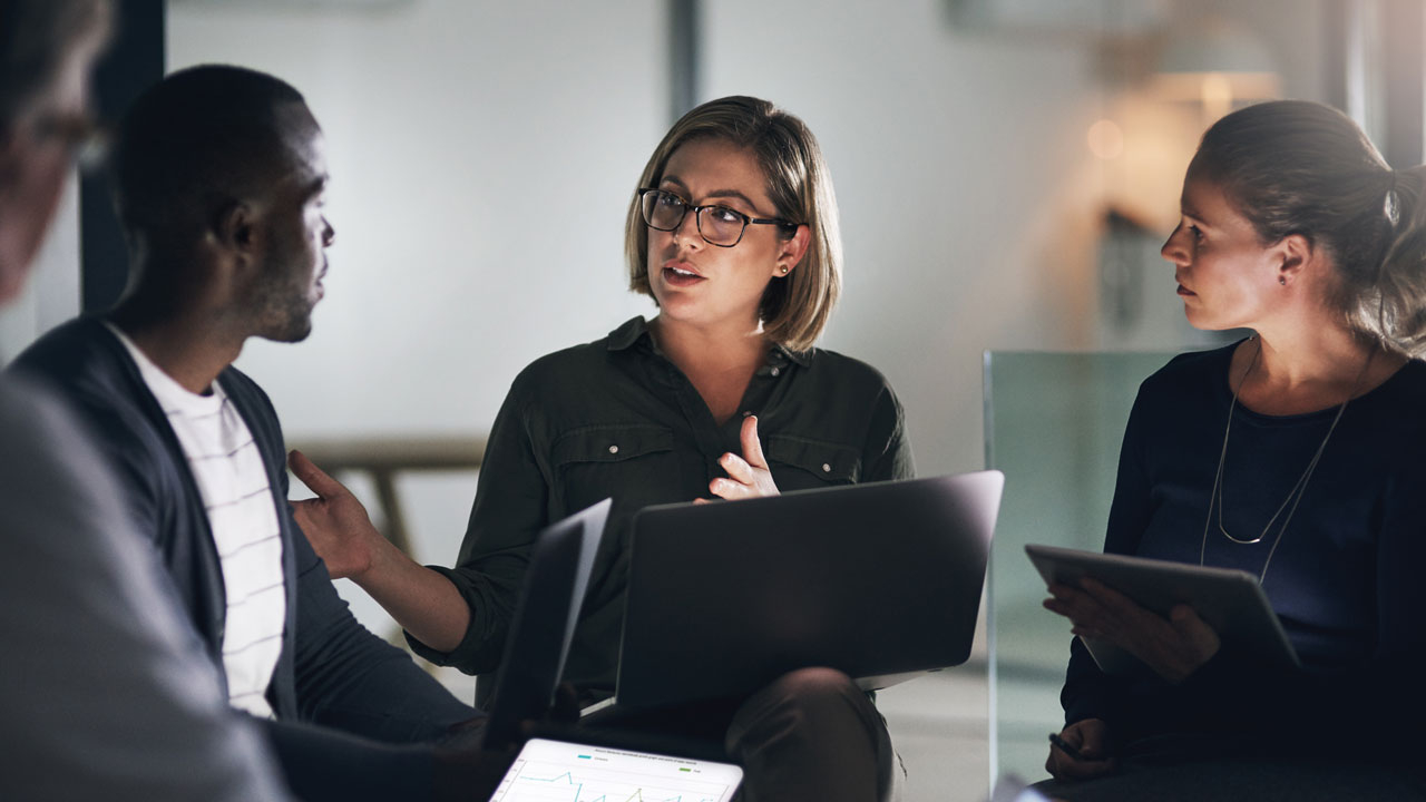 Female manager talking to her team around a table