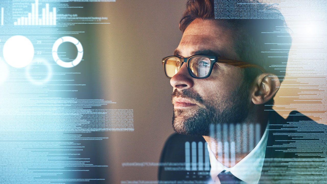 Man wearing glasses looking at screen to the left