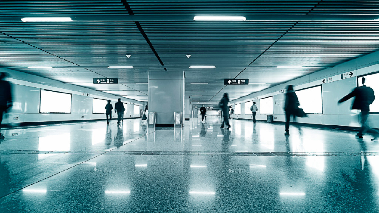 Modern train platform with few commuters